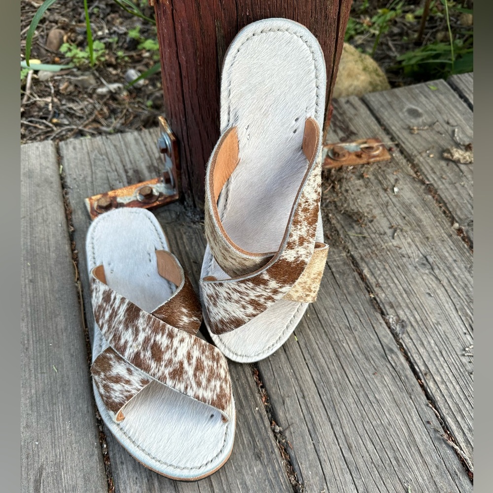 Cowhide slides. Never worn, only tried on.